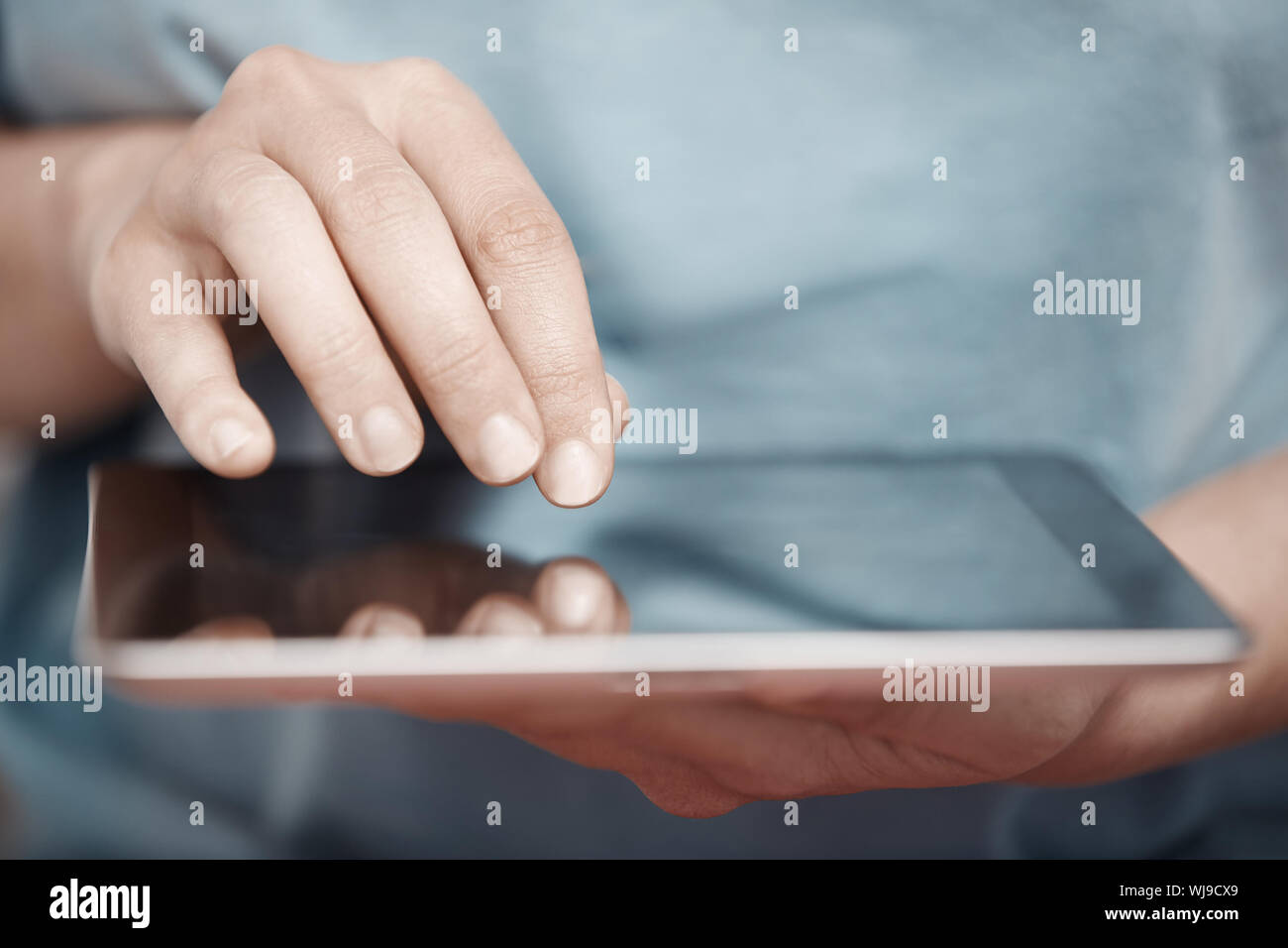 Human hands working with digital tablet Stock Photo - Alamy