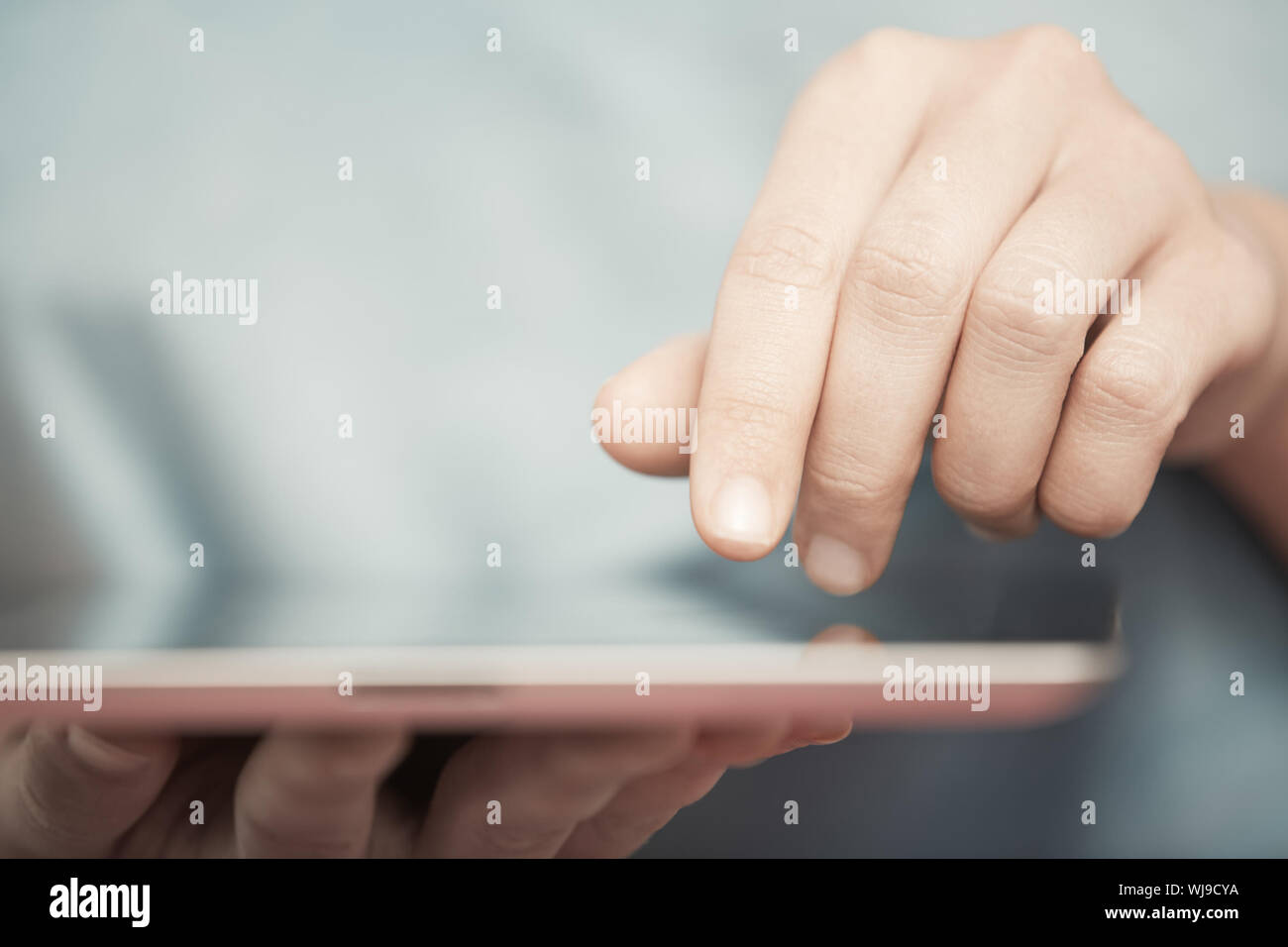 Human hands working with digital tablet Stock Photo - Alamy
