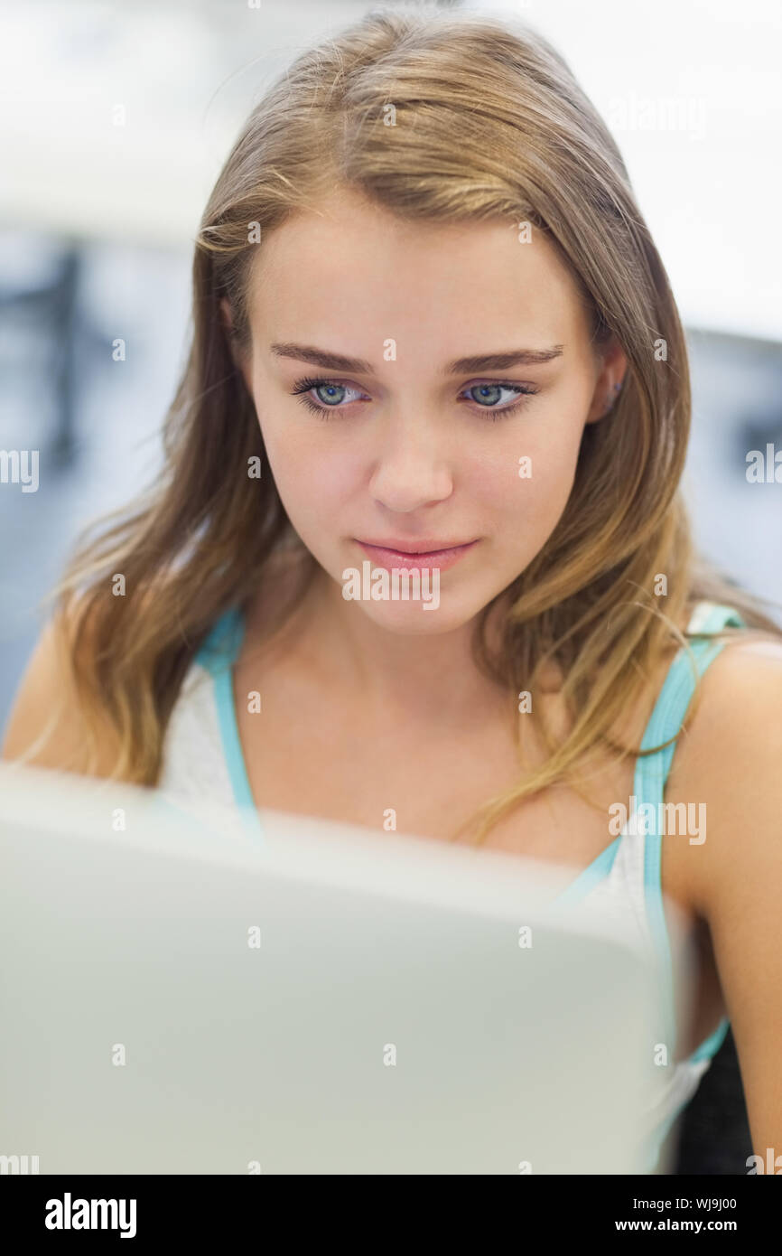 Focused pretty student working on computer in computer room at college Stock Photo