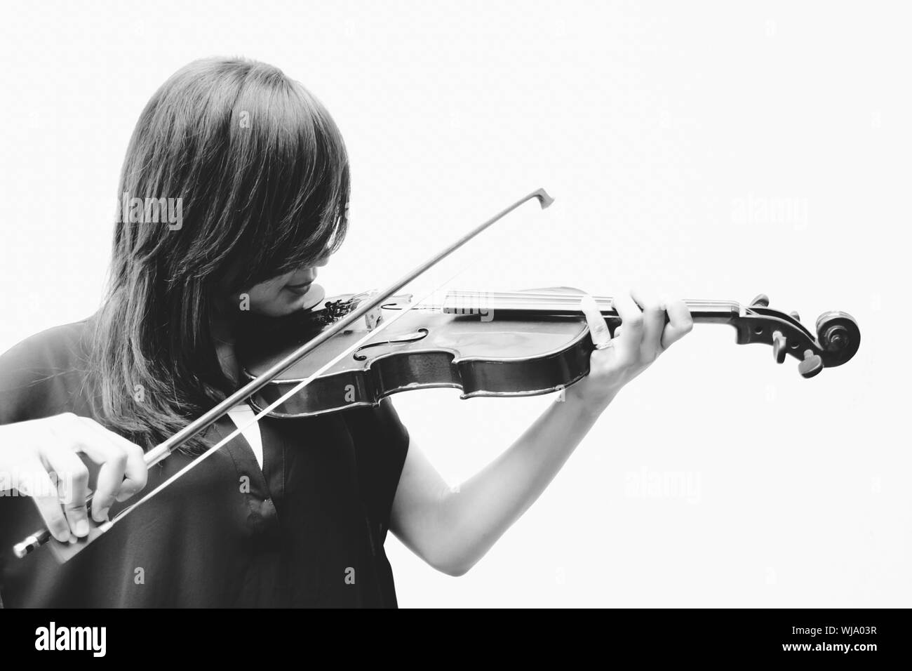 Female Violinist Playing Violin Against White Background Stock Photo