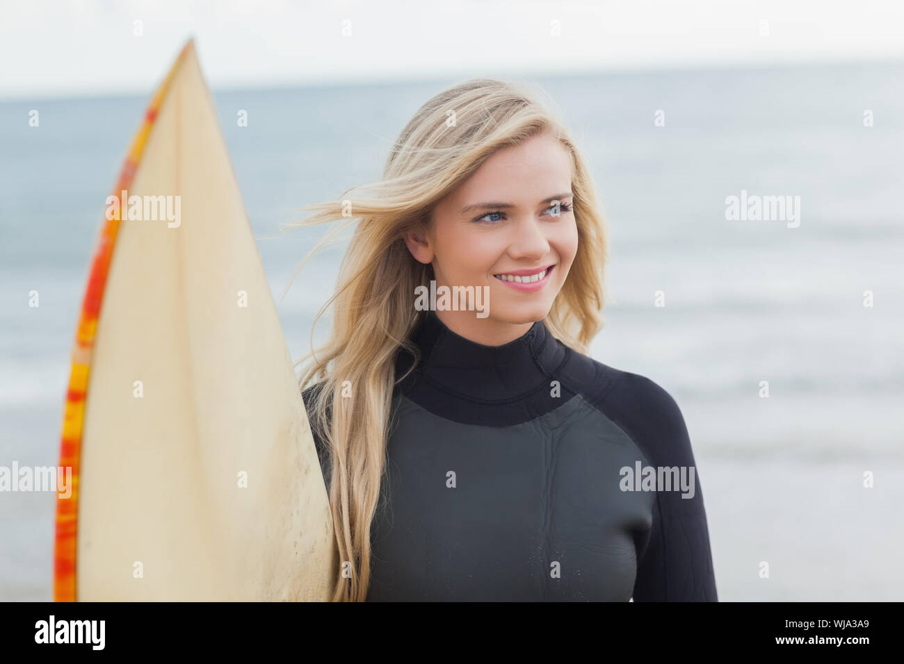 Blonde woman holding surfboard hi-res stock photography and images - Alamy