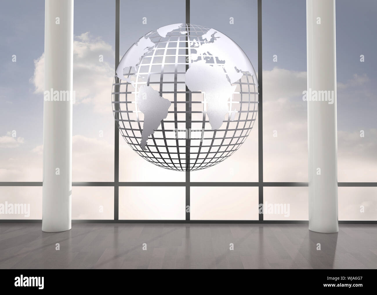 Silver globe floating in room Stock Photo