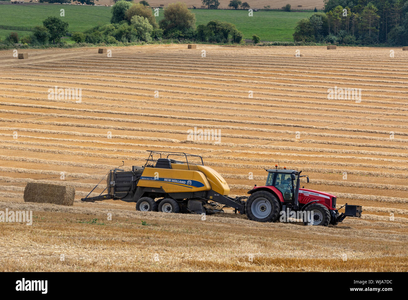 Hay Baler working in a field in the North Yorkshire countryside - United Kingdom Stock Photo