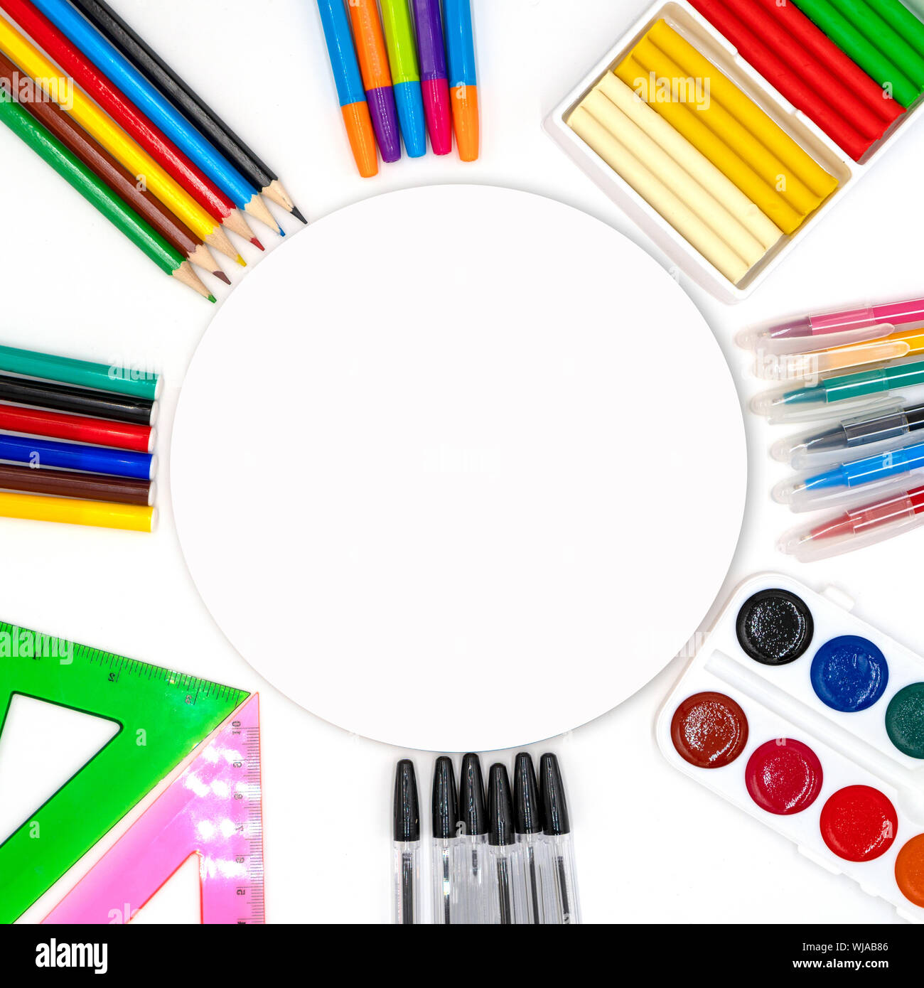 Colorful school supplies in circle arrangement on white background