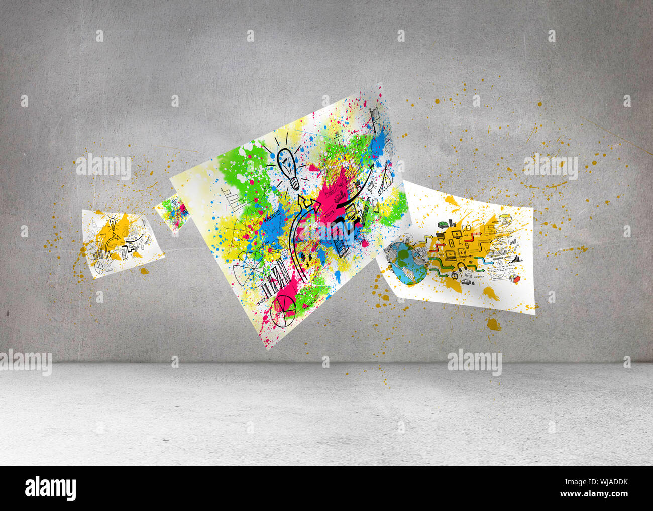 Sheets with graphics and splashes over grey wall Stock Photo