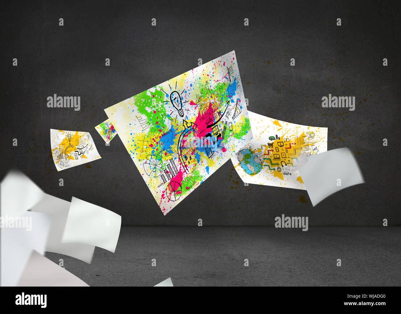 Sheets with graphics and splashes over grey wall Stock Photo