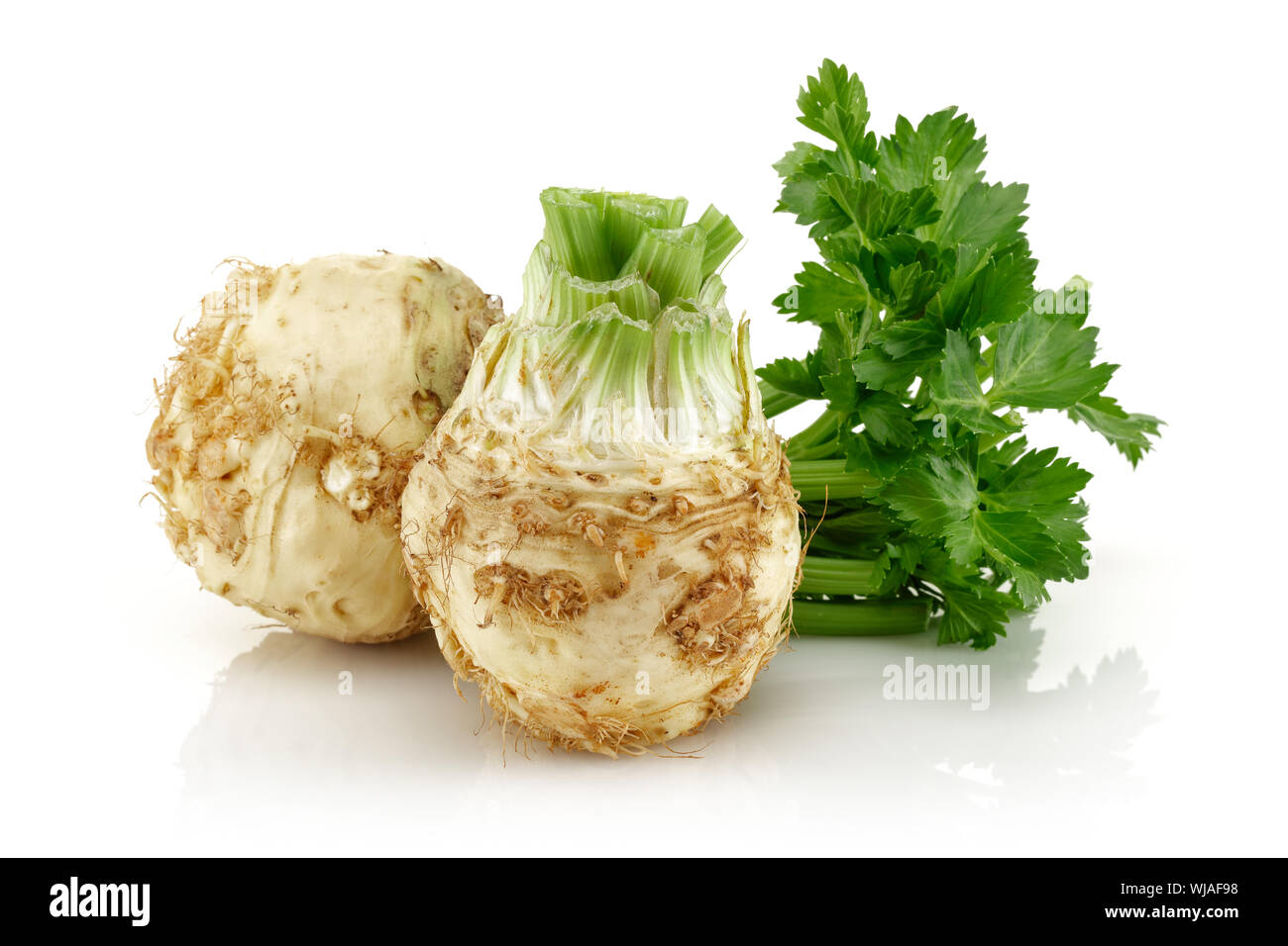 Fresh celeriac root with celery stalks isolated background Stock Photo