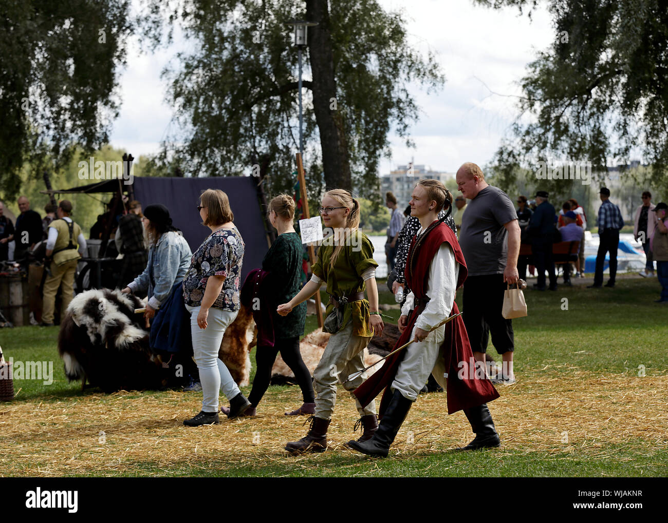 Hameenlinna Finland 08/17/2019 Medieval festival with craftsman, knights and entertainers.  The audience enjoys the sunny day in public park Stock Photo