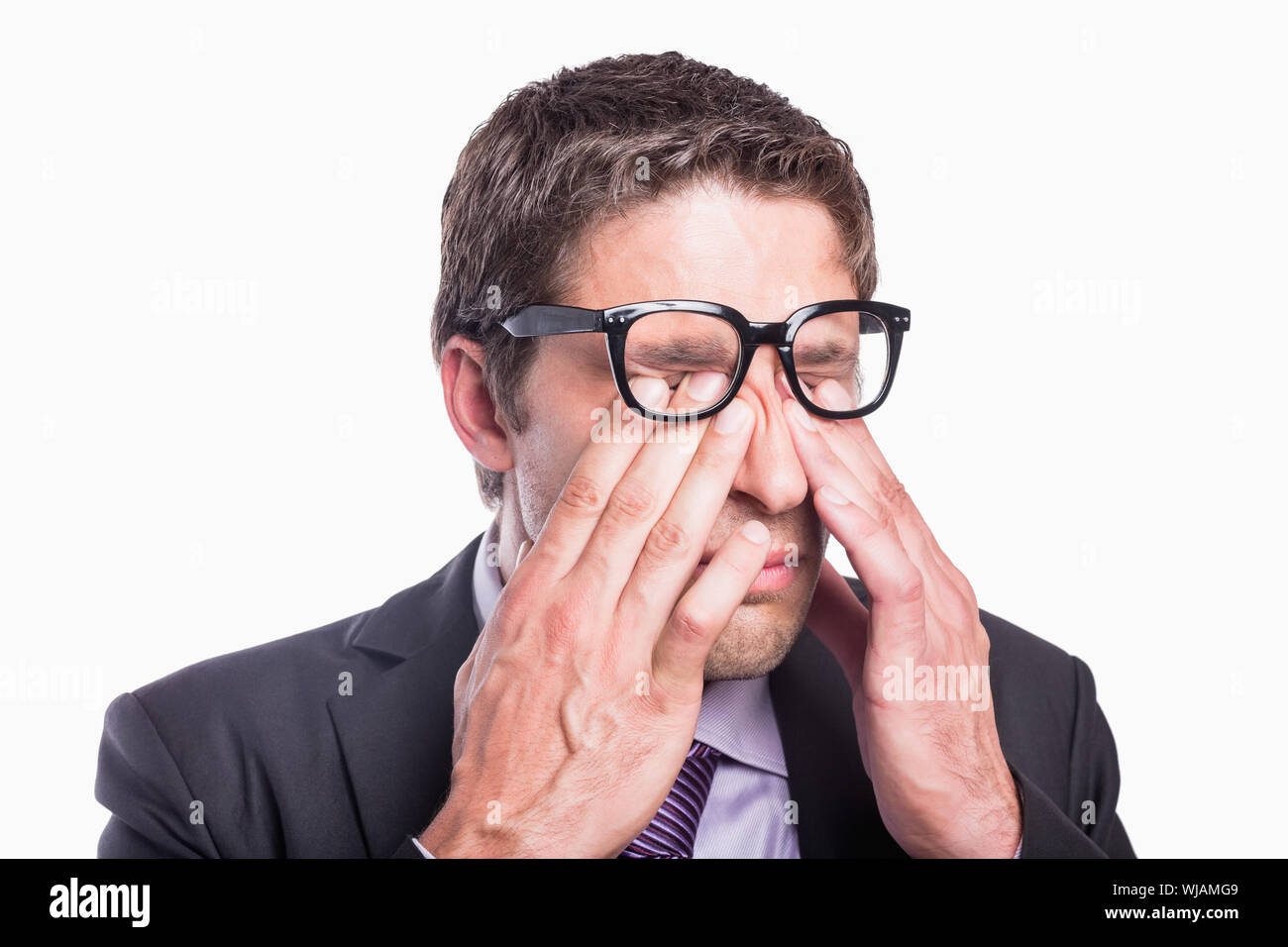 Close-up of a worried businessman rubbing eyes Stock Photo