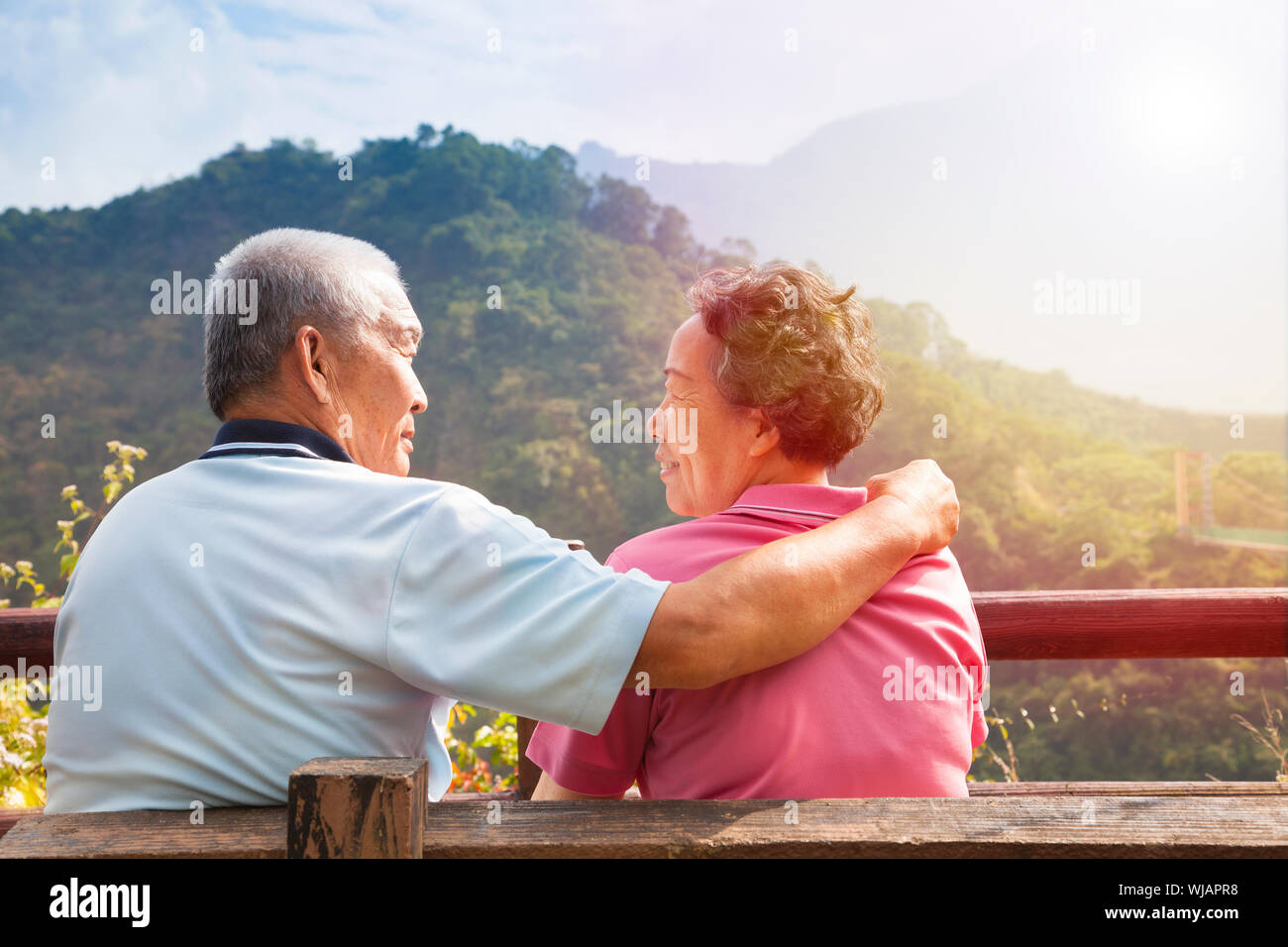 senior couple sitting on the bench in nature park Stock Photo - Alamy