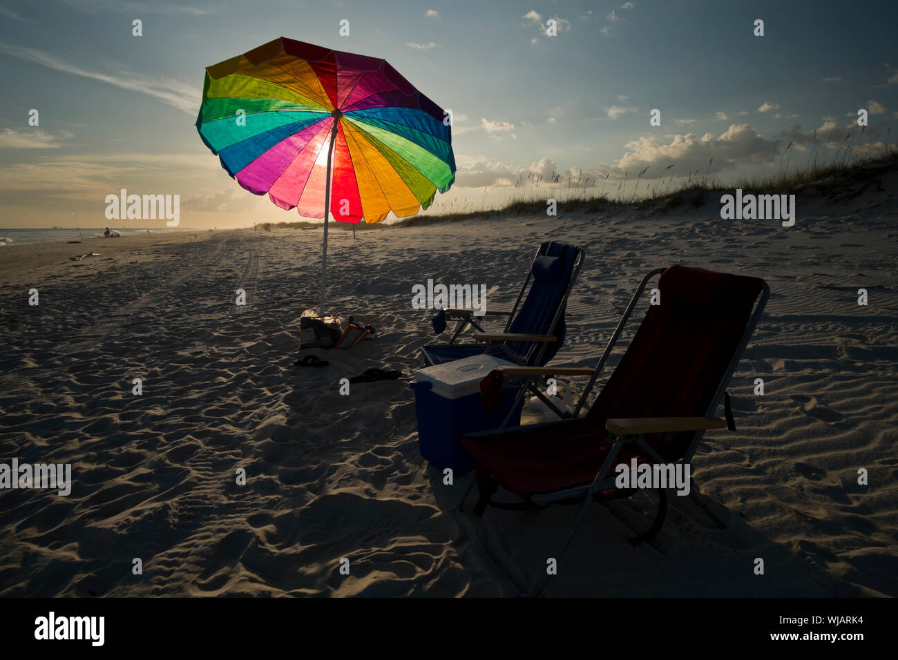 Beach umbrella and chairs in the sand next to the Gulf of Mexico on the Fort Morgan Peninsula in deep south Alabama, USA. Stock Photo