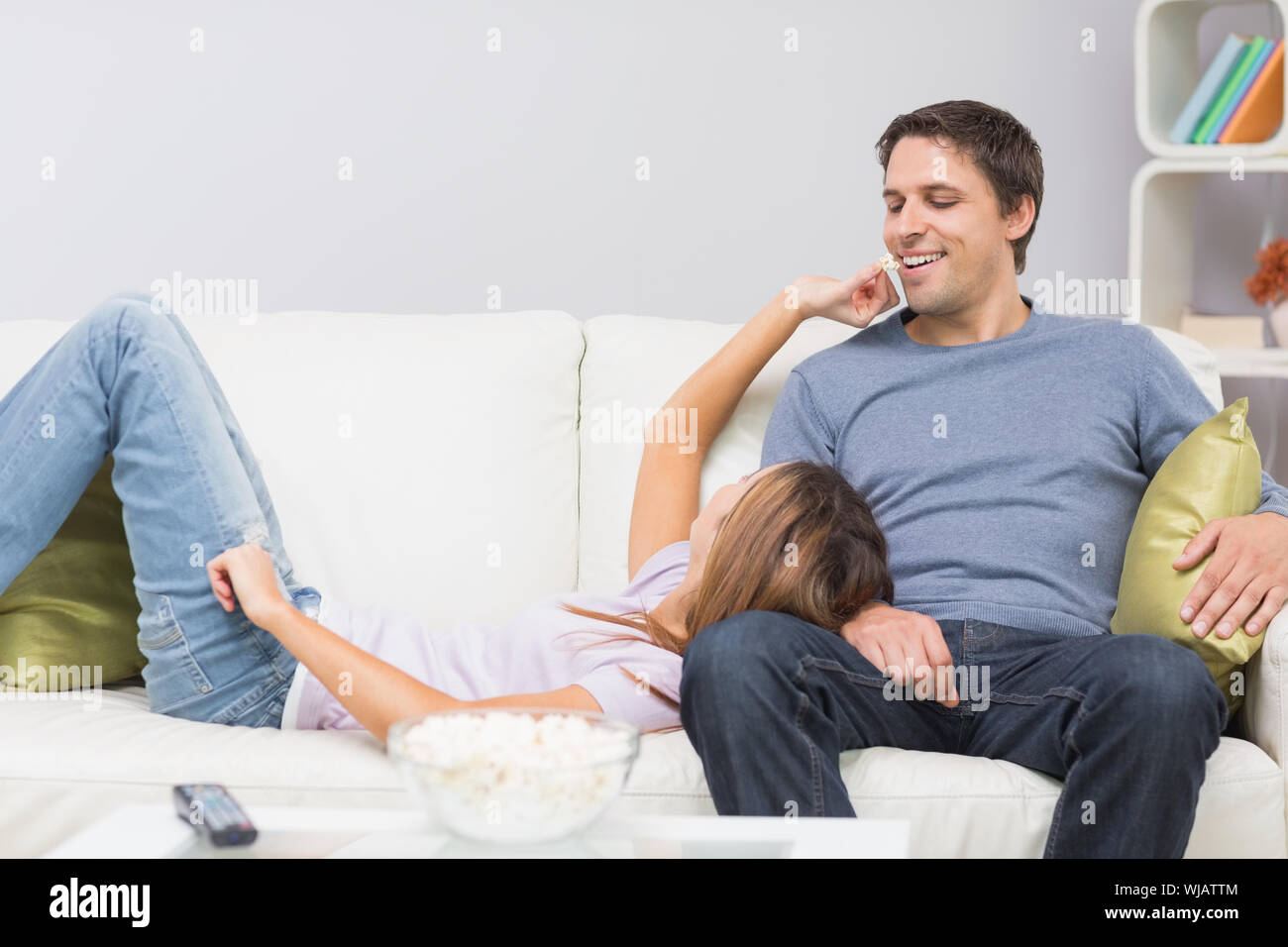 Cute and happy couple relaxing on sofa Stock Photo