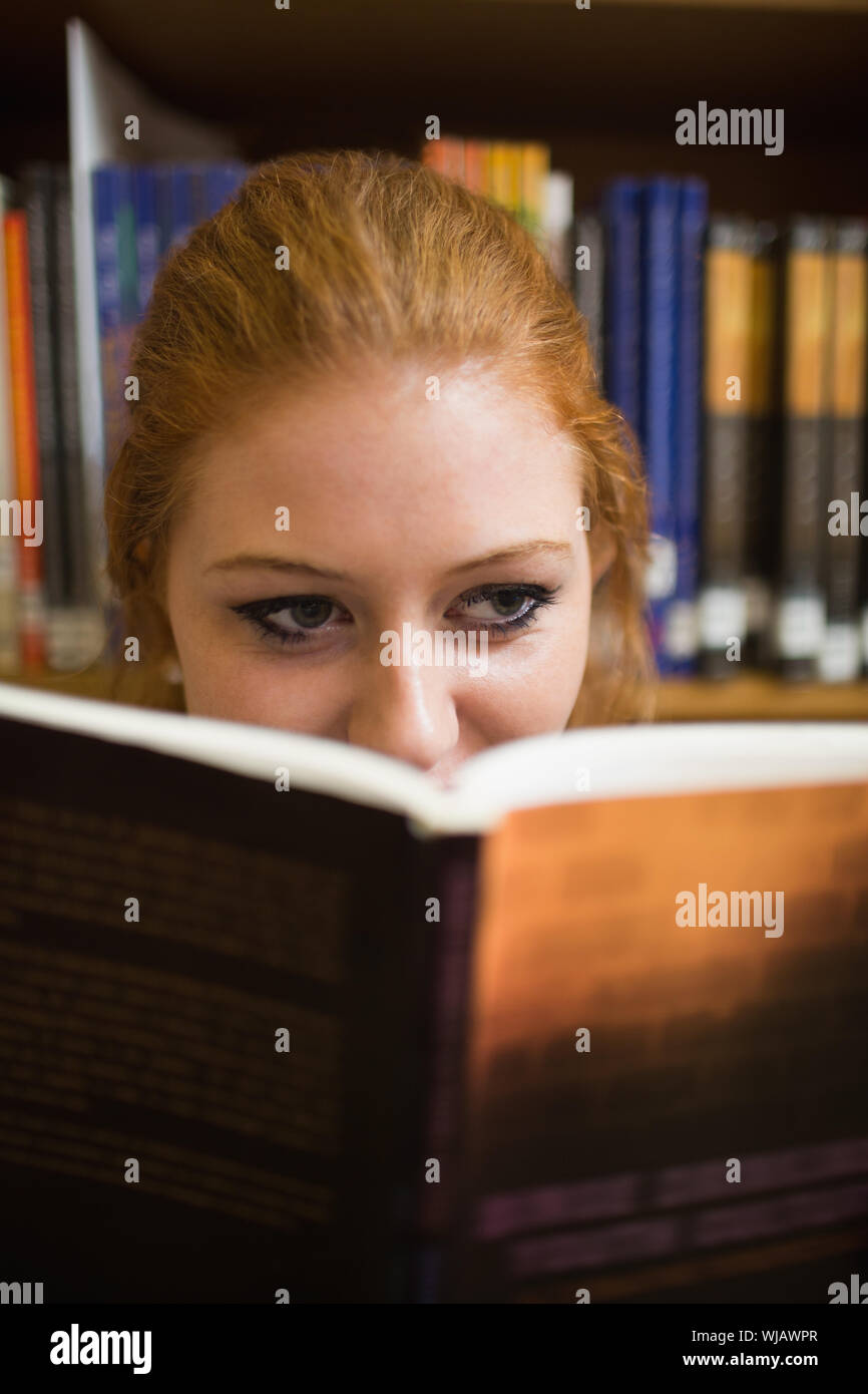 Redhead student reading a book Stock Photo Alamy