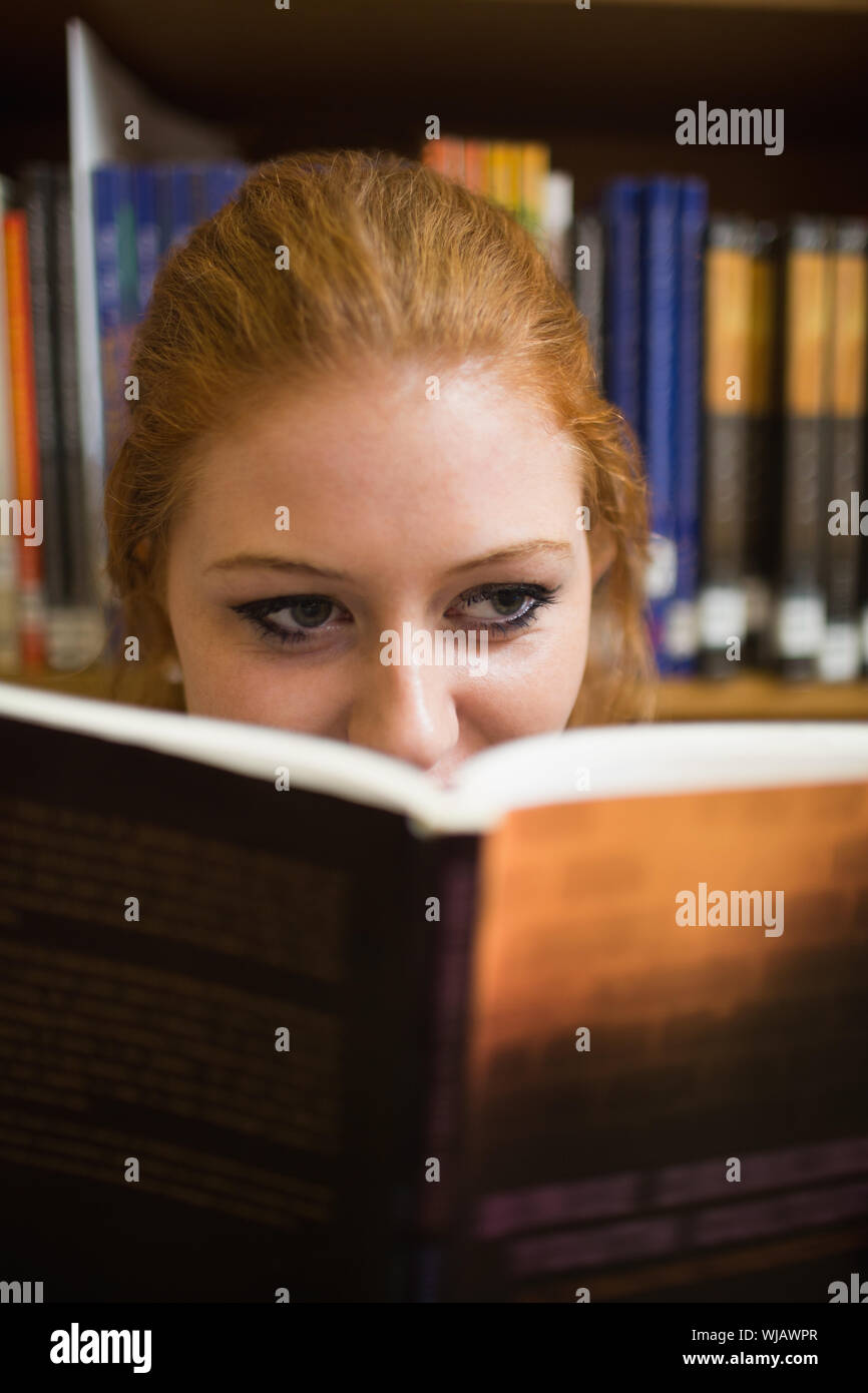 Redhead student reading a book Stock Photo