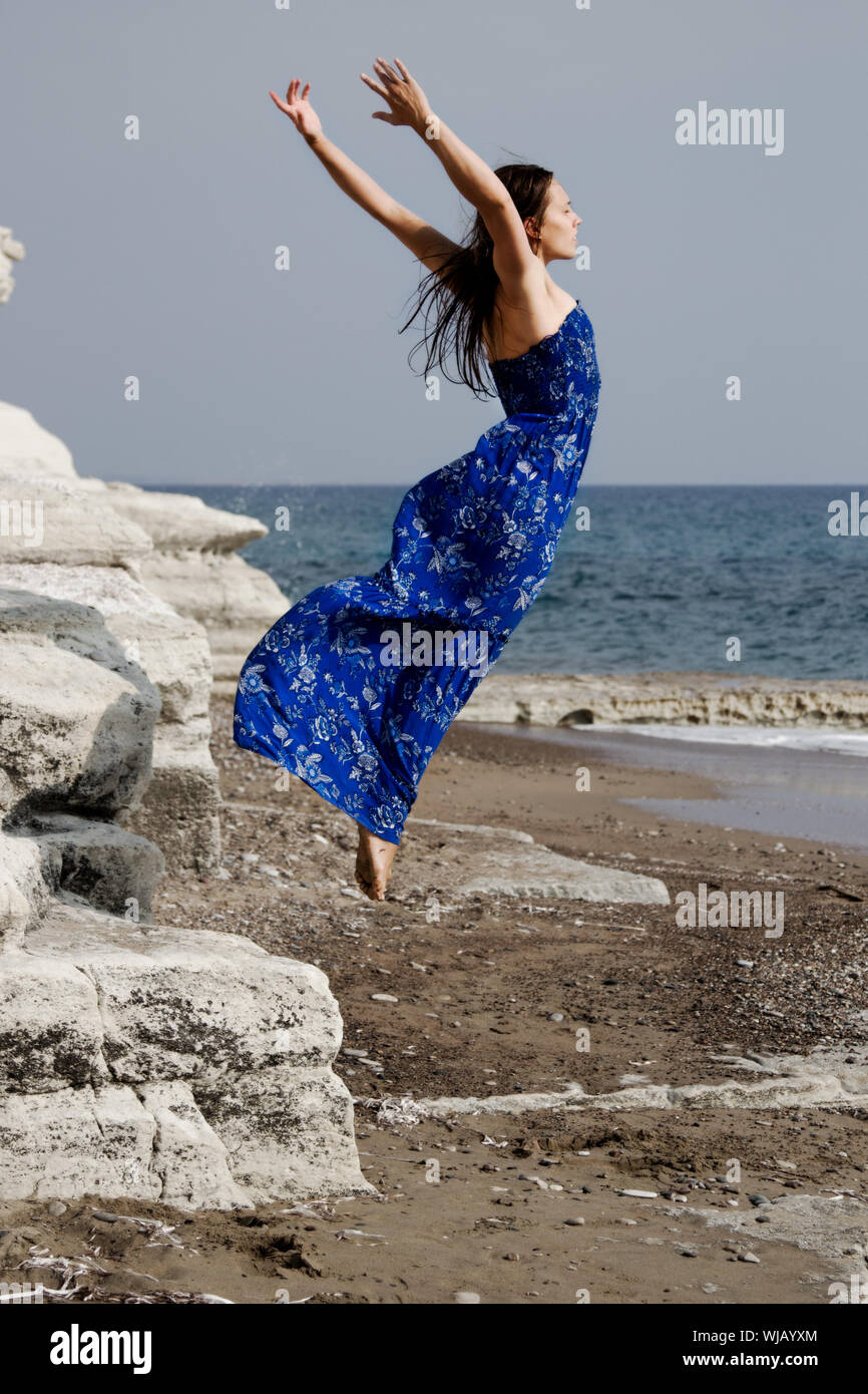 Woman jumping rock formation hi-res stock photography and images - Alamy