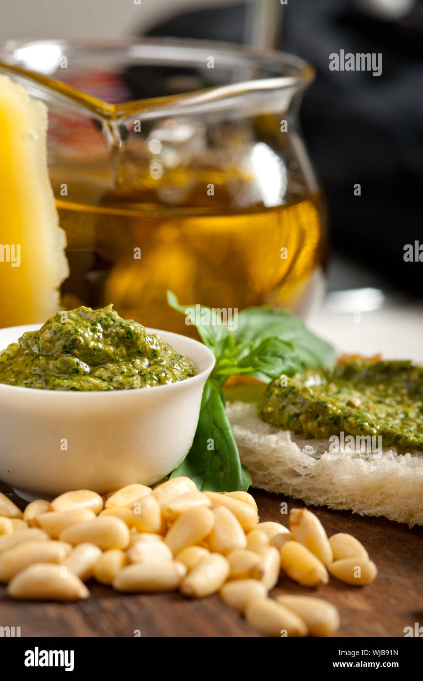Italian basil pesto bruschetta ingredients over old wood macro Stock