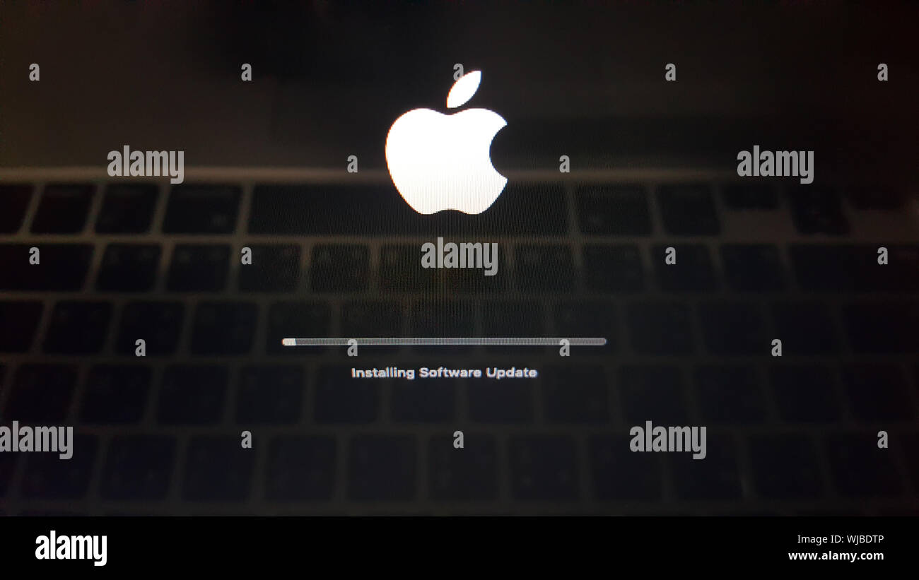 BANGKOK, THAILAND - AUGUST 28, 2019: Apple has a new update on MacOS operating system. The black screen with Apple logo of Macbook laptop is booting a Stock Photo