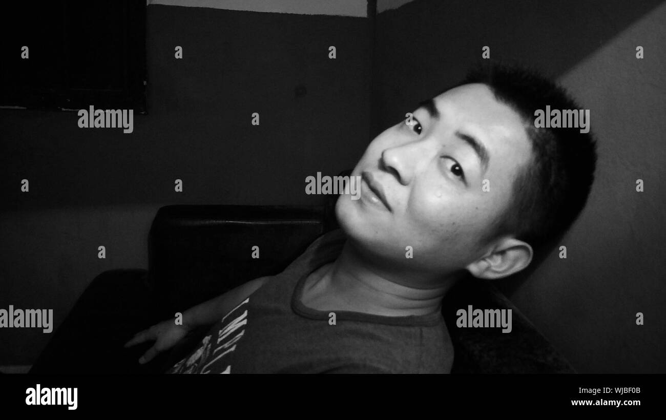 Portrait Of Man By Wall At Home Stock Photo Alamy