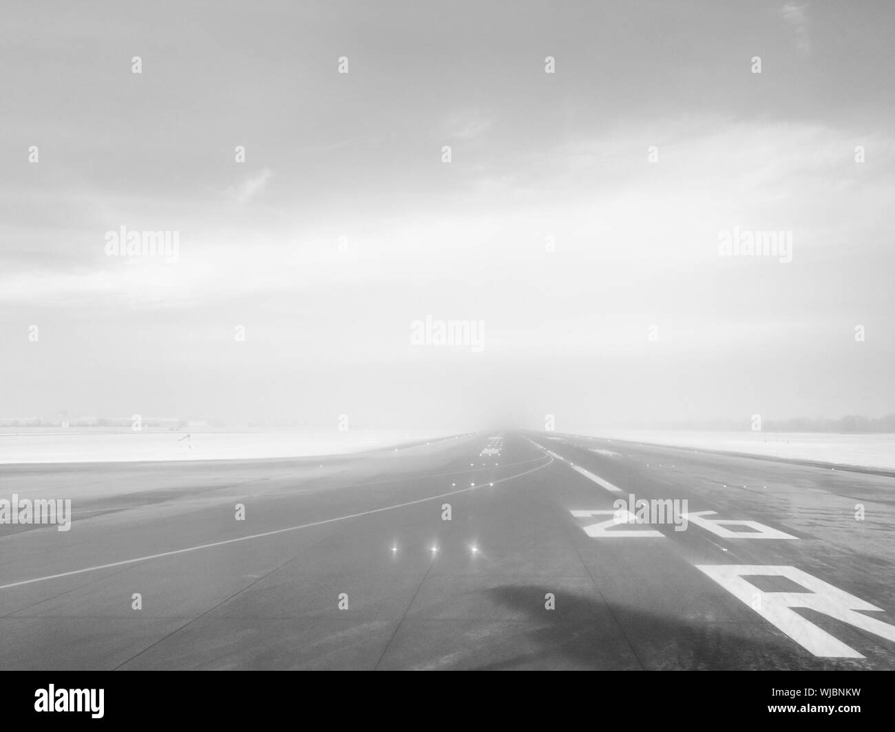 Empty Airport Runway Against Sky Stock Photo