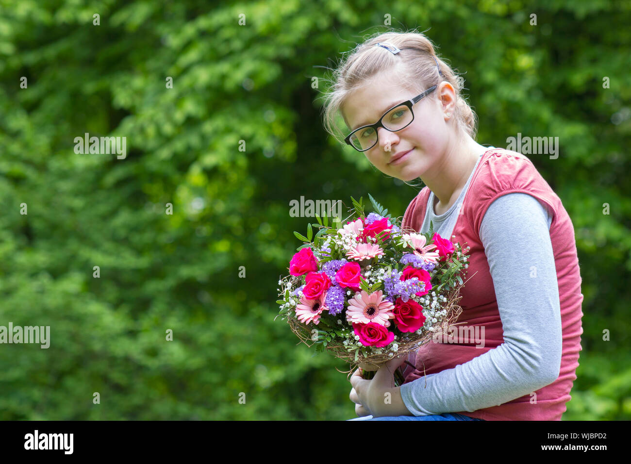 portrait of a beautiful young girl with flowers Stock Photo - Alamy