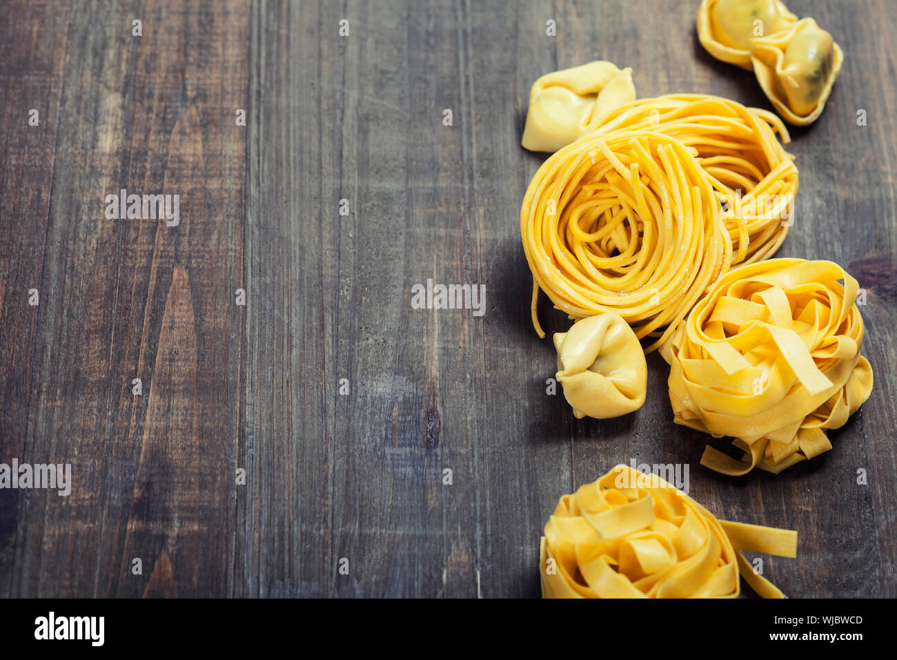 Fresh pasta on wooden table Stock Photo