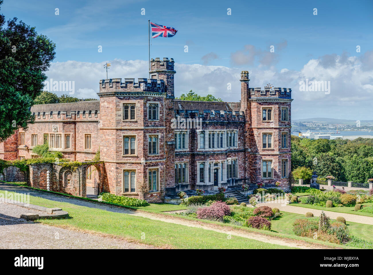 A beautiful red sandstone stately home, Edgcumbe House, Torpoint, Cornwall, overlooking the Tamar Valley and river towards Plymouth and Dartmoor. Stock Photo