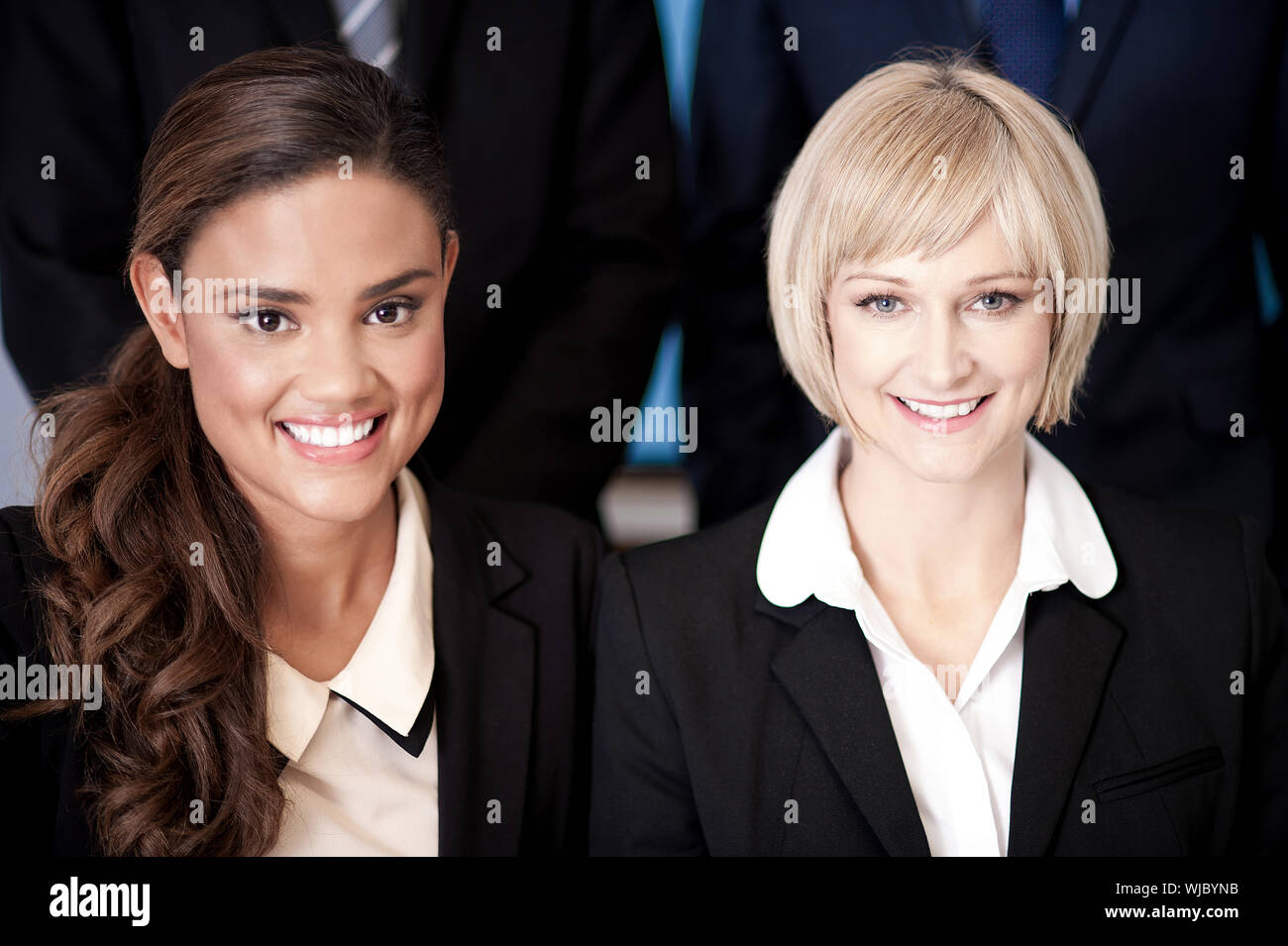 Beautiful business women posing together Stock Photo - Alamy
