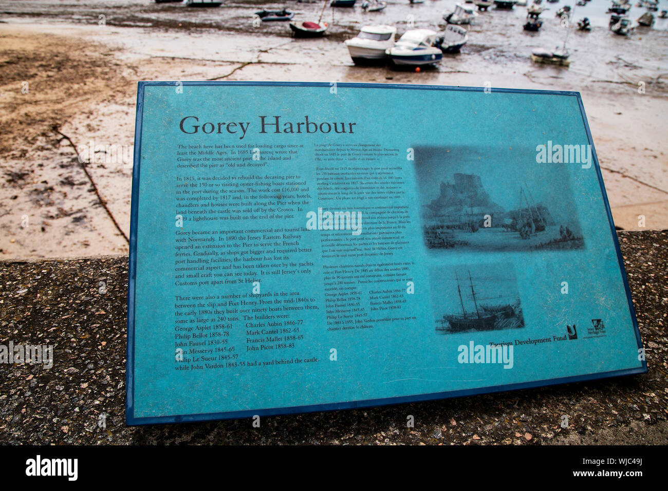 A sign depicting the history of Gorey Castle and harbour, Jersey Stock Photo Alamy
