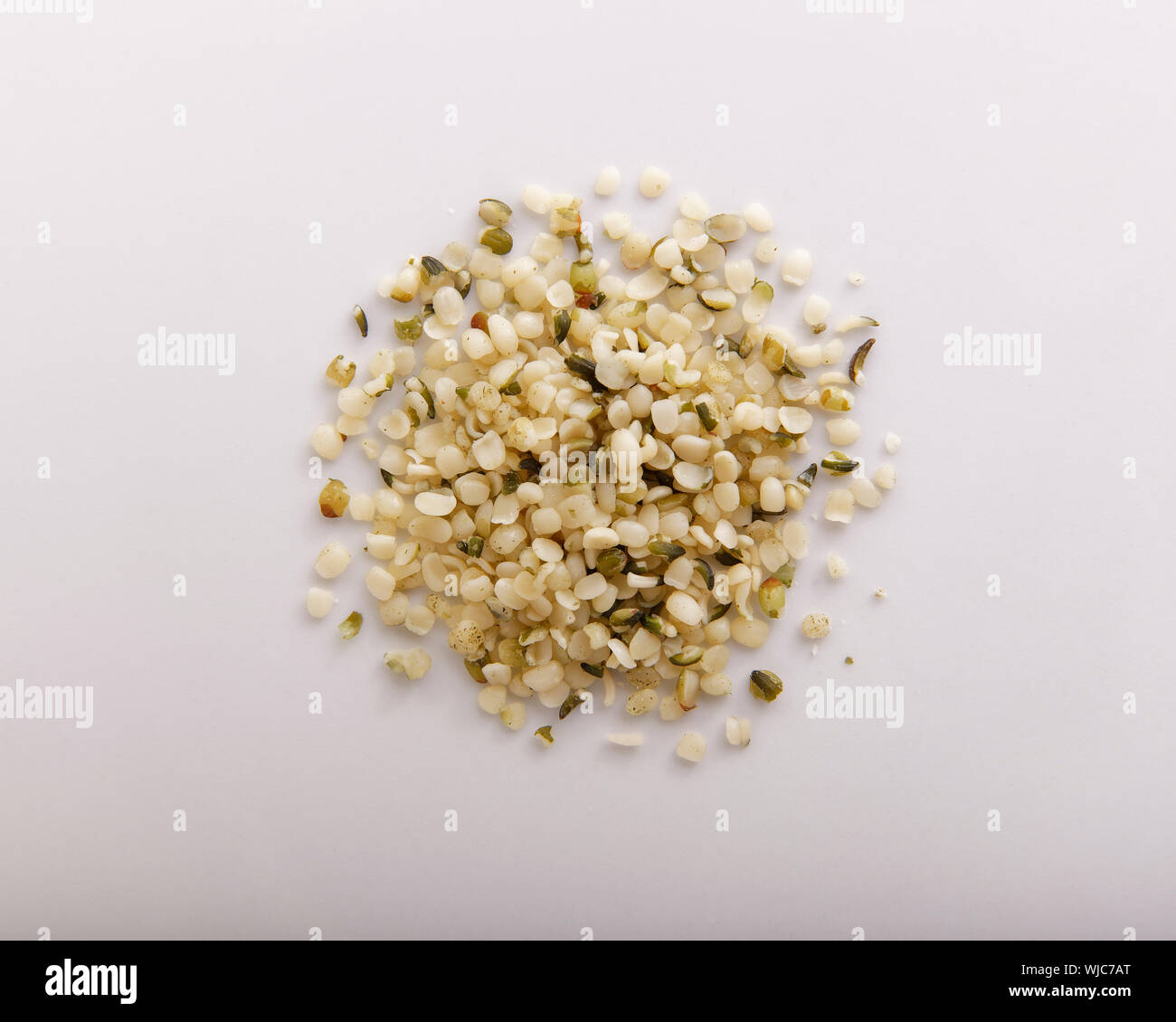 Hemp seeds piled and seen from above, closeup Stock Photo