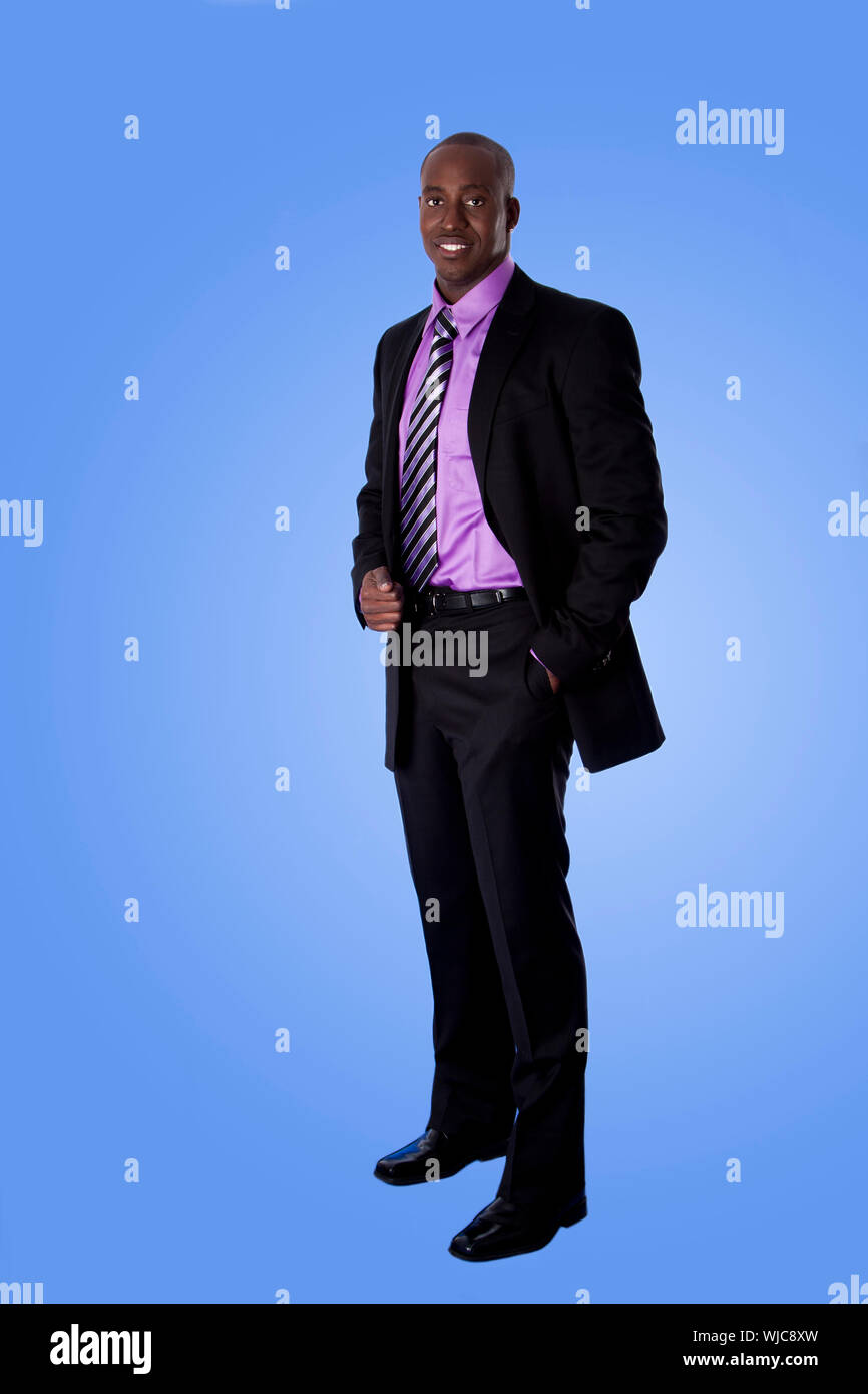 Handsome happy African American corporate business man smiling wearing black suit with purple shirt standing with authority with hand in pocket is Stock Photo Alamy