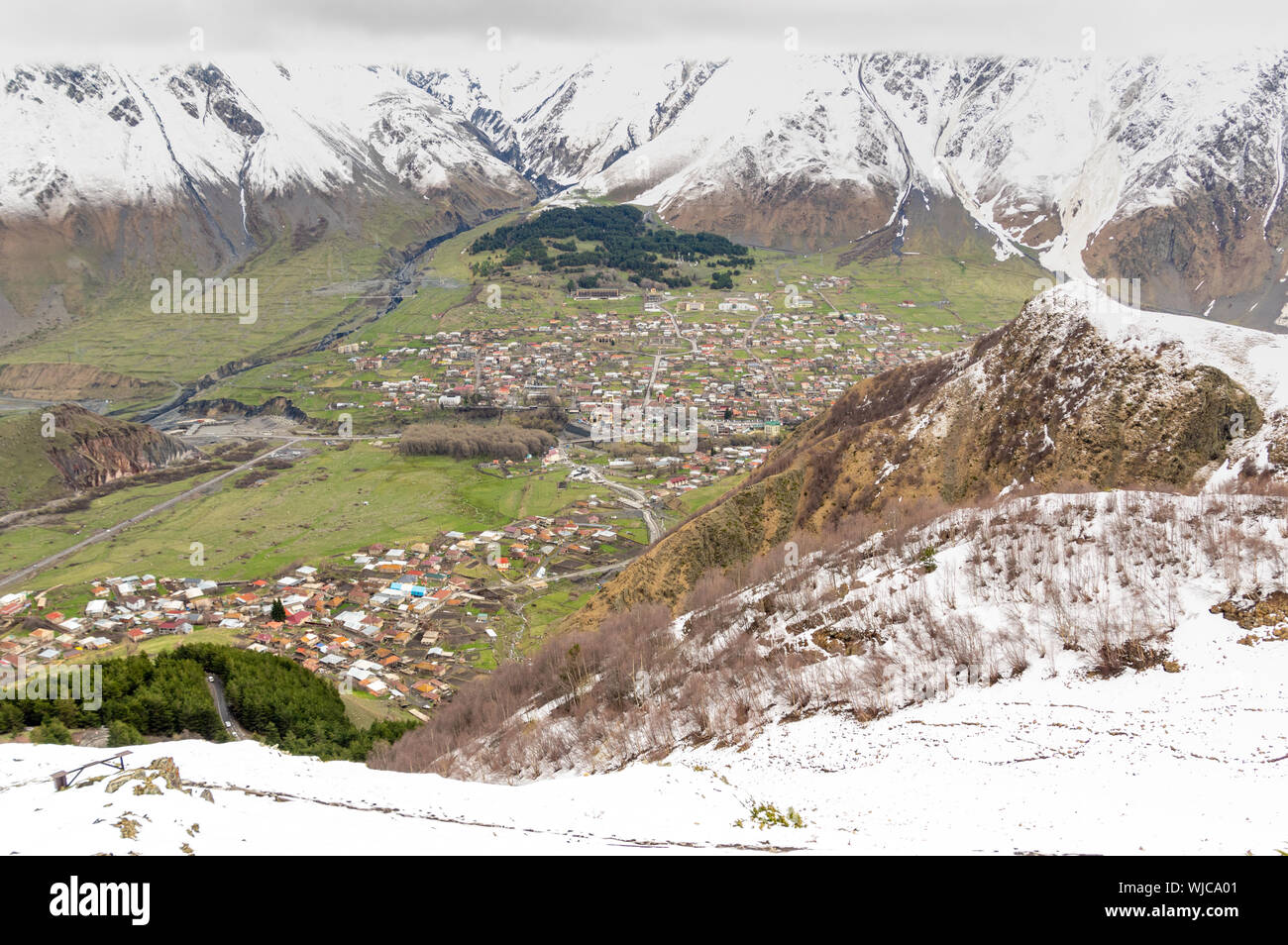 Overview of the town of Stepantsminda in the Greater Caucasus mountains just below the Mount Kazbek Stock Photo