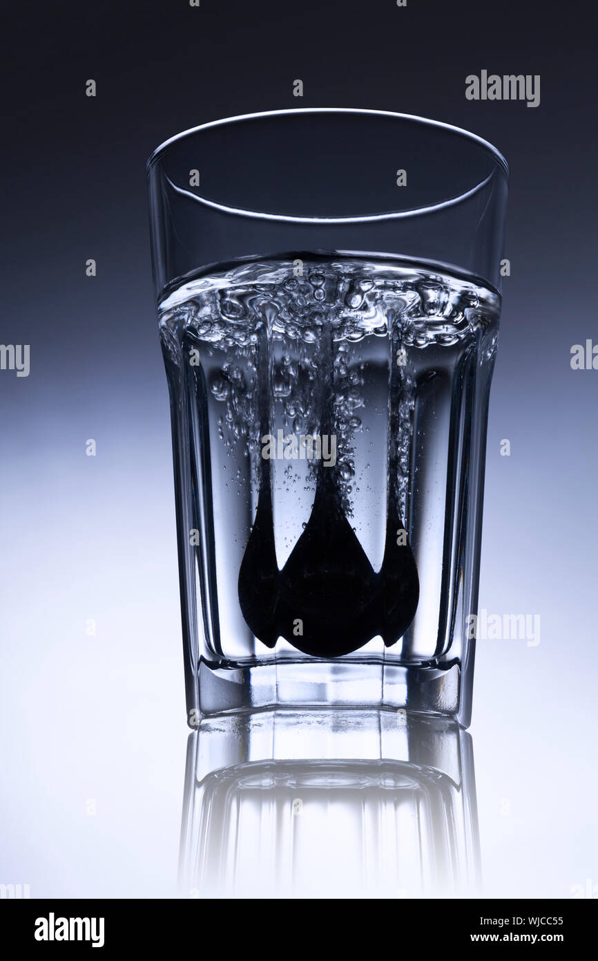 simple waterglass with spoon and bubbles Stock Photo Alamy