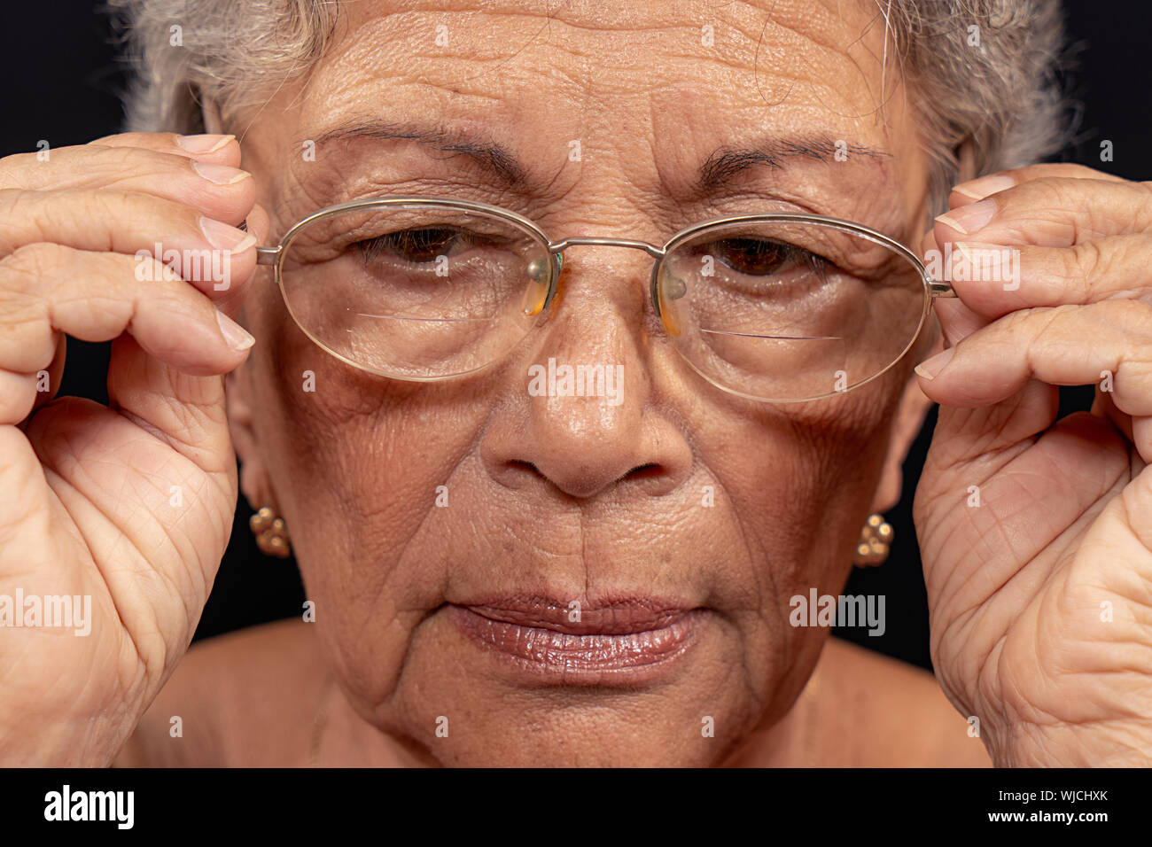 Old wrinkled woman wearing glasses Stock Photo
