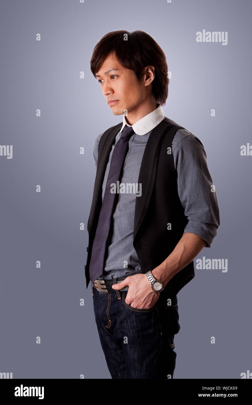 Depressed casual Asian business man with sad look, side view, wearing jeans  and dress shirt with tie, isolated Stock Photo - Alamy