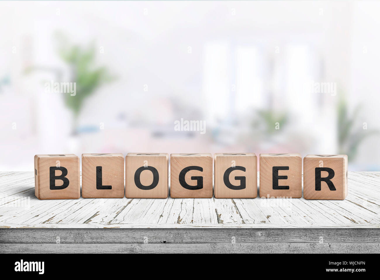 Blogger Sign In A Bright Living Room With Green Plants In The Background Stock Photo Alamy