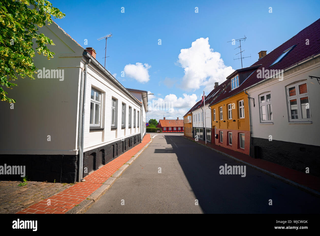 Empty street in a small danish village with colorful buildings in the summer Stock Photo