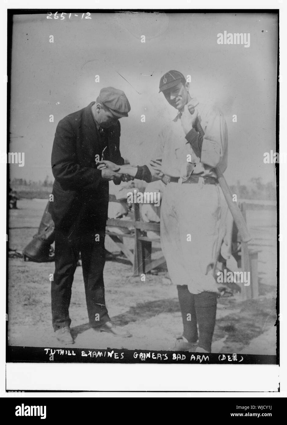 Harry Tuthill, Detroit Tigers trainer, examines bad arm of Del Gainer