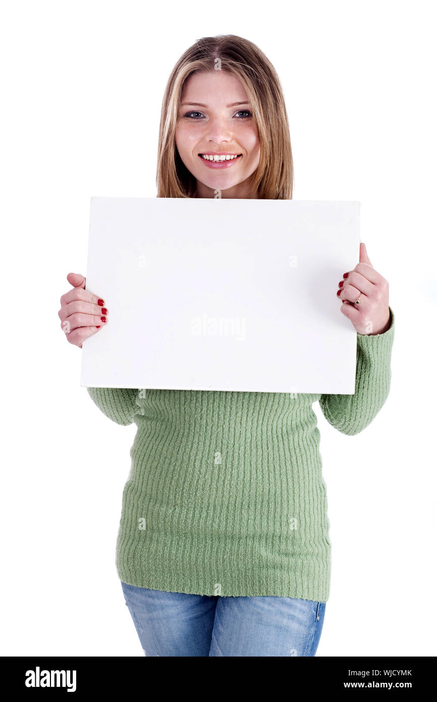 Smiling young beautiful girl holding blank white board over white ...