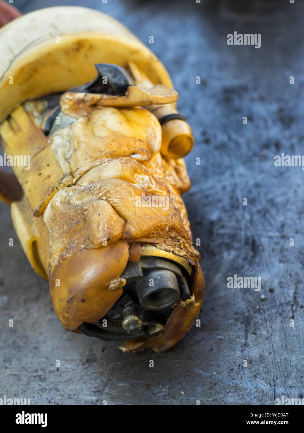 Close-up Of Broken Fuel Pump On Scratched Metal Table Stock Photo
