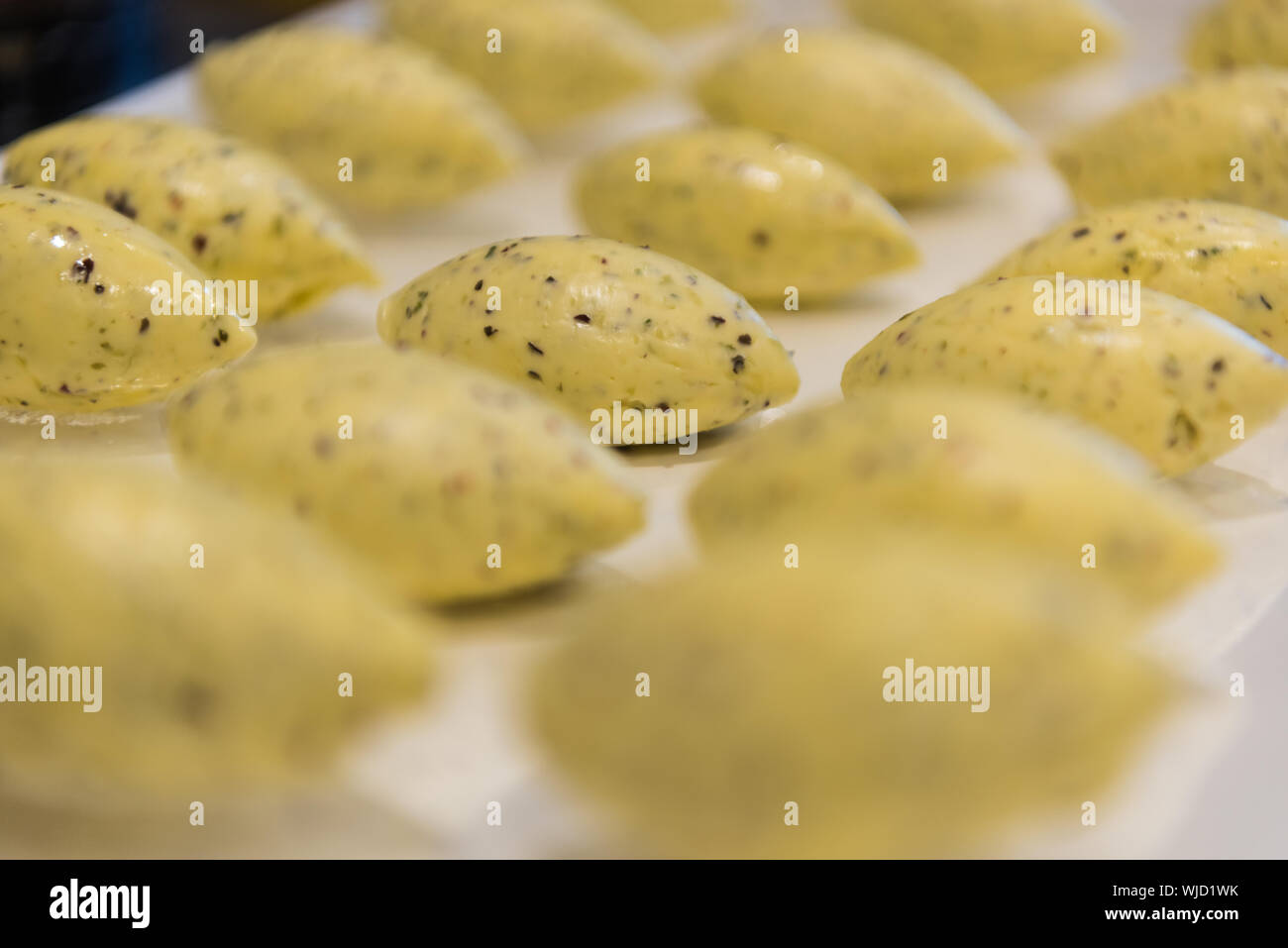 Seaweed butter quenelles in rows on a tray Stock Photo Alamy