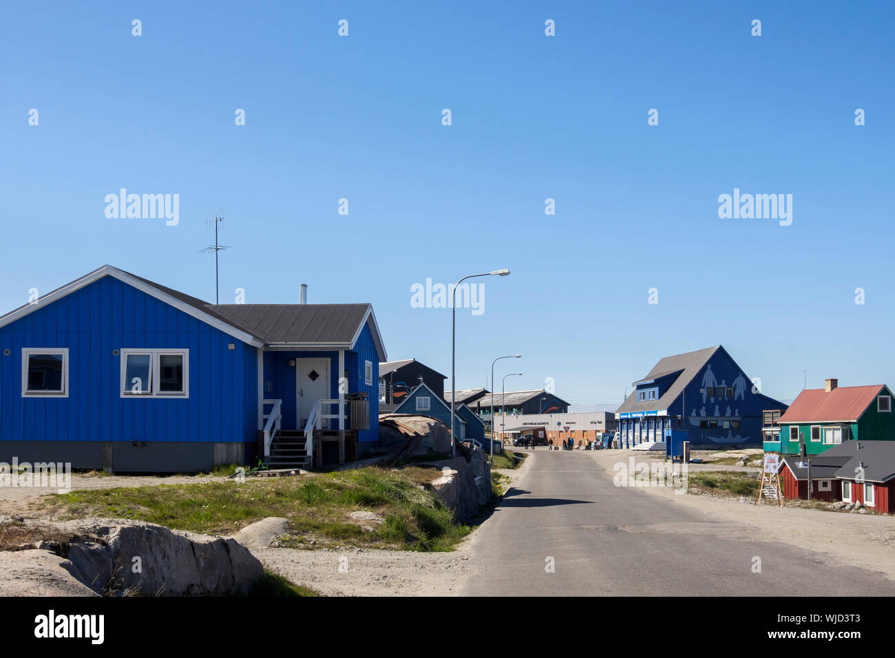 Typical wooden houses on street leading to town and Tourist Information centre. Ilulissat (Jakobshavn), Qaasuitsup, Greenland Stock Photo