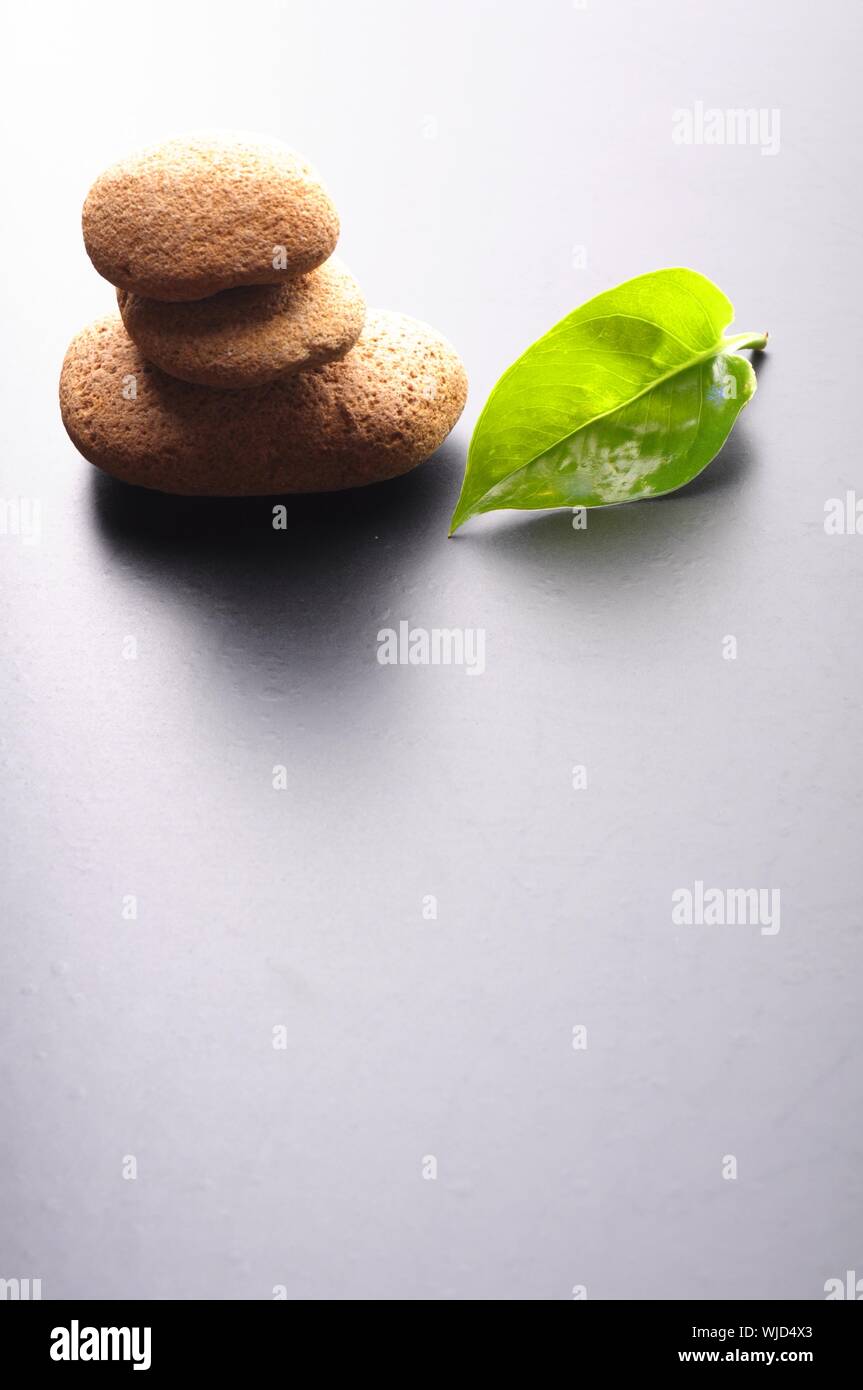 massage still life with zen stones leaf and black copyspace Stock Photo