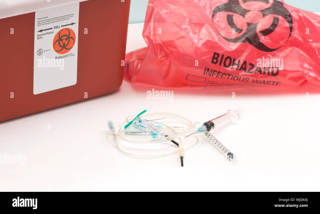 Used medical equipment with biohazard bag and sharps container Stock