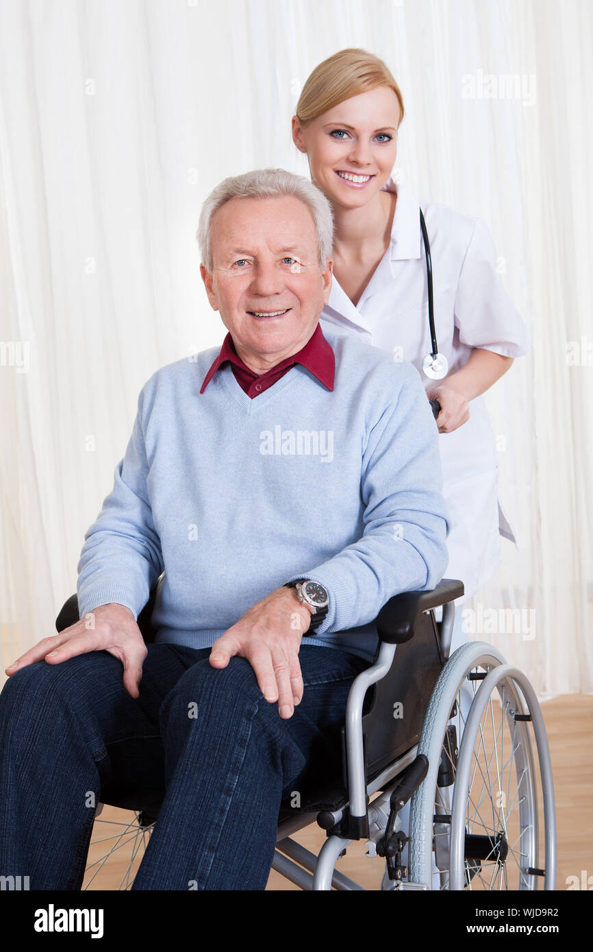 Caring Doctor Helping Handicapped Patient Stock Photo