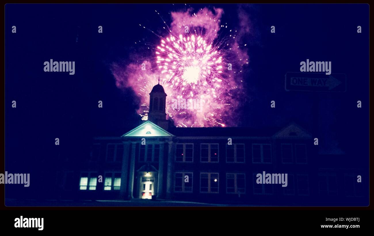 Low Angle View Of Firework Display Above Warren Hills Middle School At Night Stock Photo
