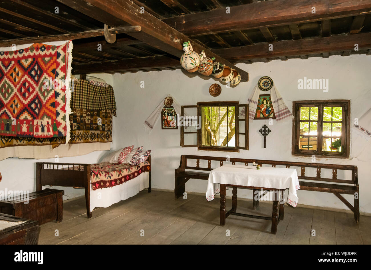 Interior of a house from Bancu, Harghita. National Village Museum at Herastrau Park, Bucharest. Romania Stock Photo