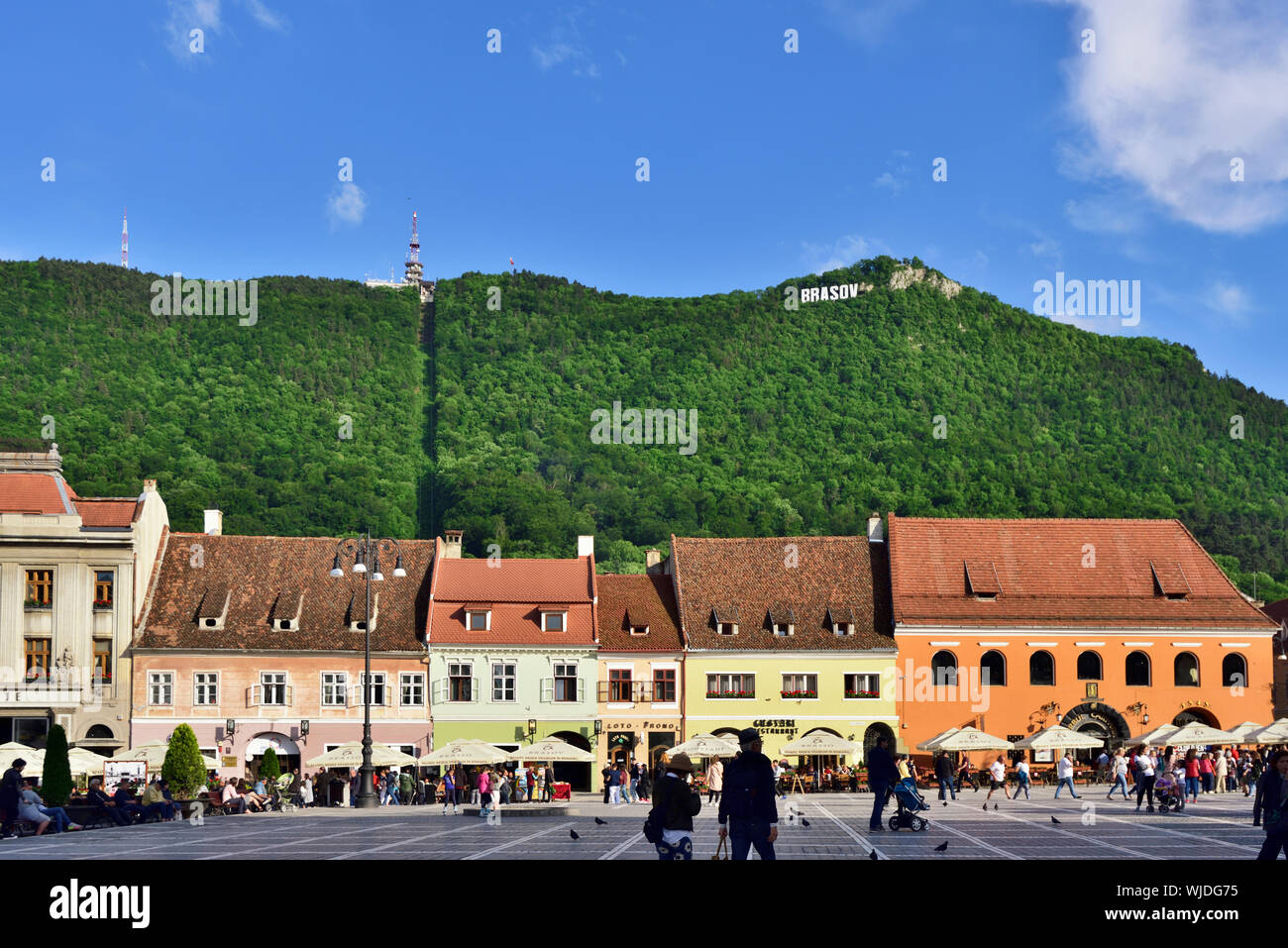 Houses in Piata Sfatului (Council Square) and Tampa mountain. Brasov, Transylvania. Romania Stock Photo