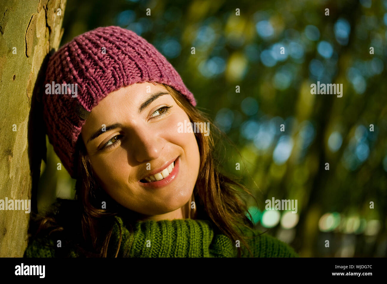 Autumn portrait of a beautiful young woman close to a tree Stock Photo ...