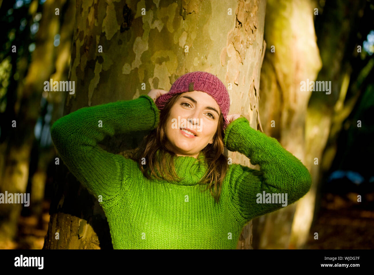 Autumn portrait of a beautiful young woman close to a tree Stock Photo ...