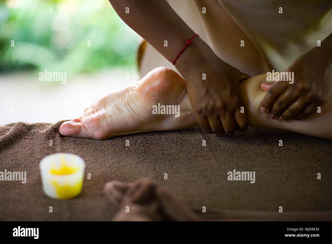 Therapist making spa reflexology foot massage Stock Photo